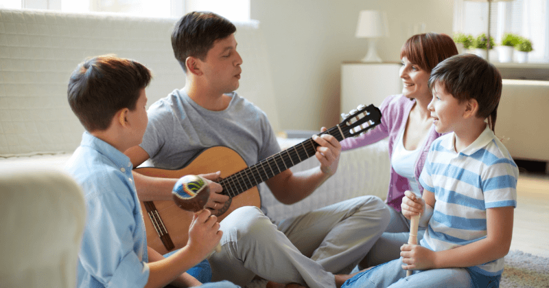 Dad playing the guitar for his family